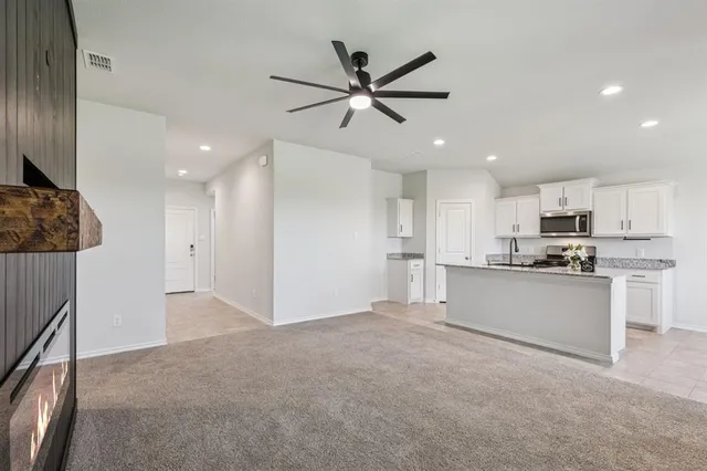 a view of a kitchen with a sink and dishwasher a refrigerator with wooden floor