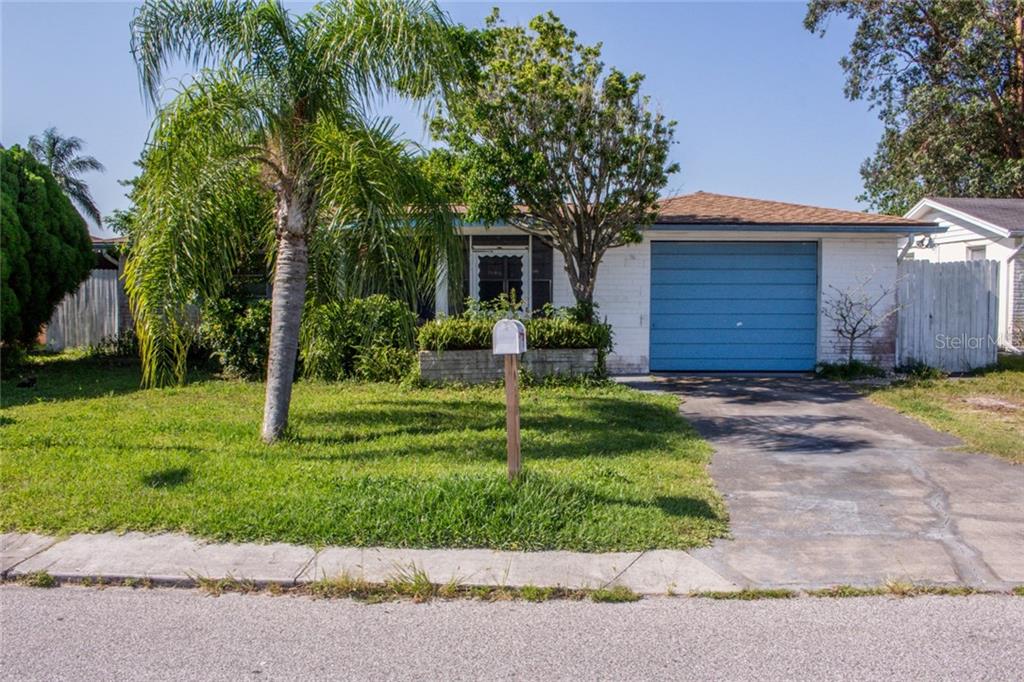 3548 Umber Road Holiday, FL 34691 - Photo 1 of 1 a view of a house with a yard and palm trees