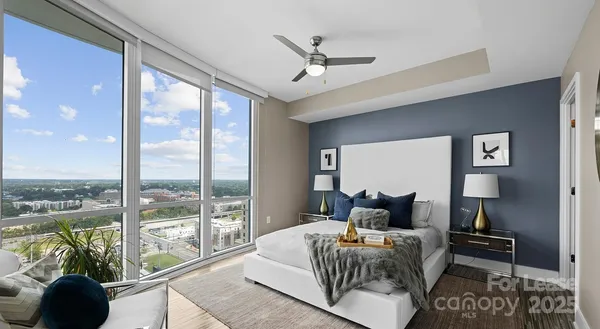 a bedroom with a bed and glass window