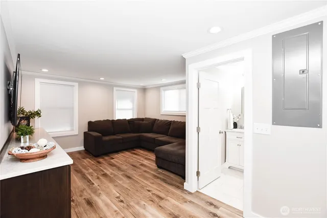 a living room with furniture and a potted plant