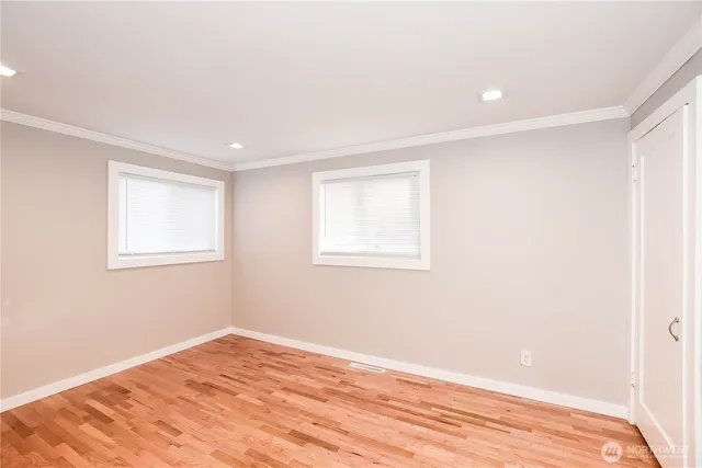 a view of a room with wooden floor and fan