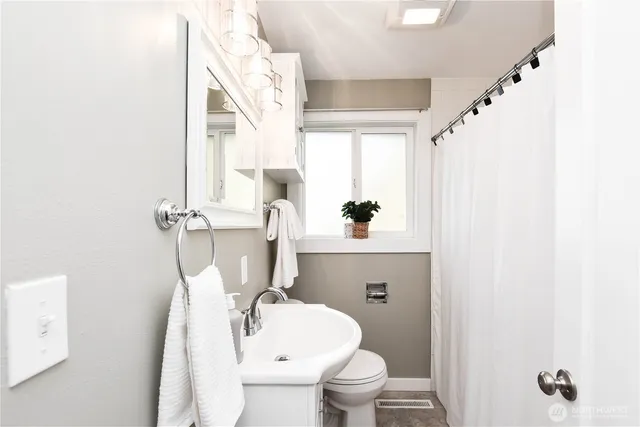 a bathroom with a toilet and a sink