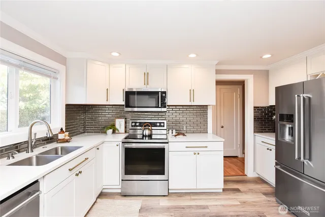 a kitchen with a sink stove and refrigerator