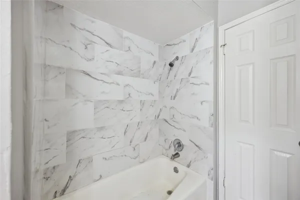 a bathroom with a bathtub and shower