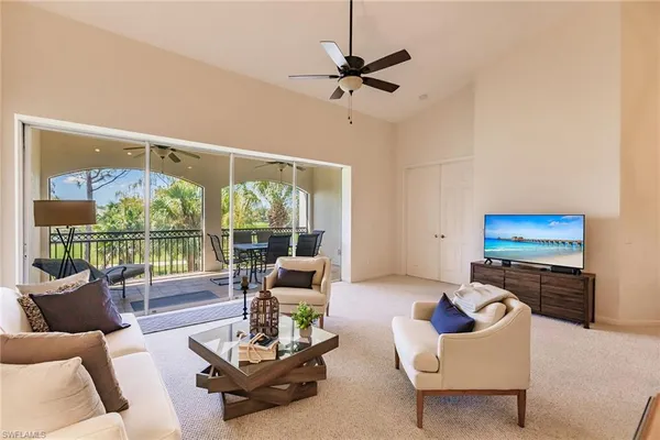 a room with a table chairs and a lamp