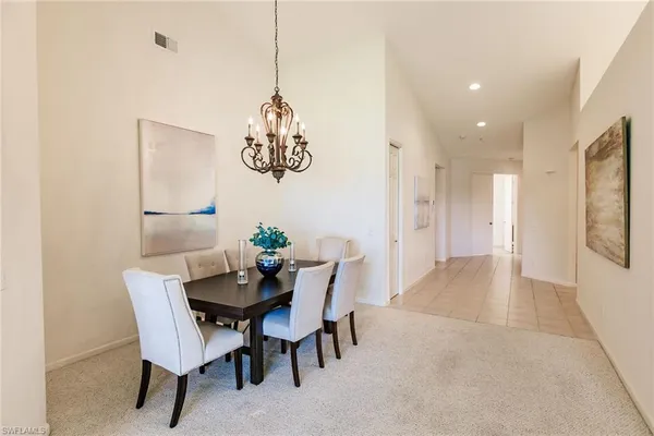 a view of a dining room with furniture and front door
