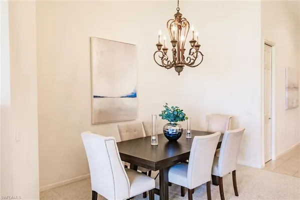 a view of a dining room with furniture and chandelier