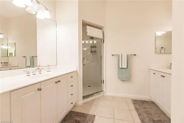 a bathroom with a shower sink and mirror