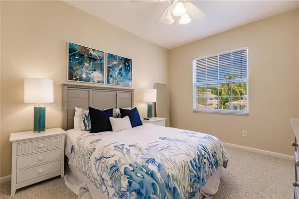 a bedroom with a bed and a mirror