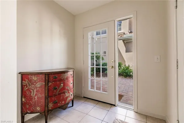 a view of staircase with white walls and white door