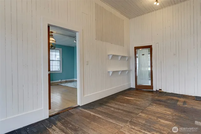 an empty room with wooden floor and closet