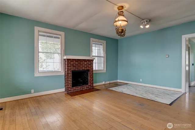an empty room with windows and entryway