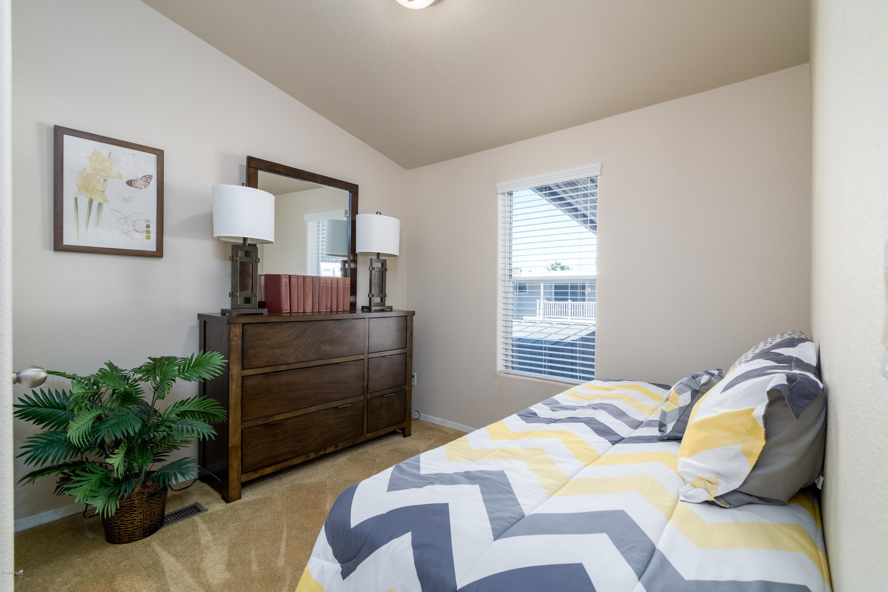 2132 Bluejay Avenue Oxnard, CA 93033 - Photo 14 of 20 a bedroom with a bed and a potted plant