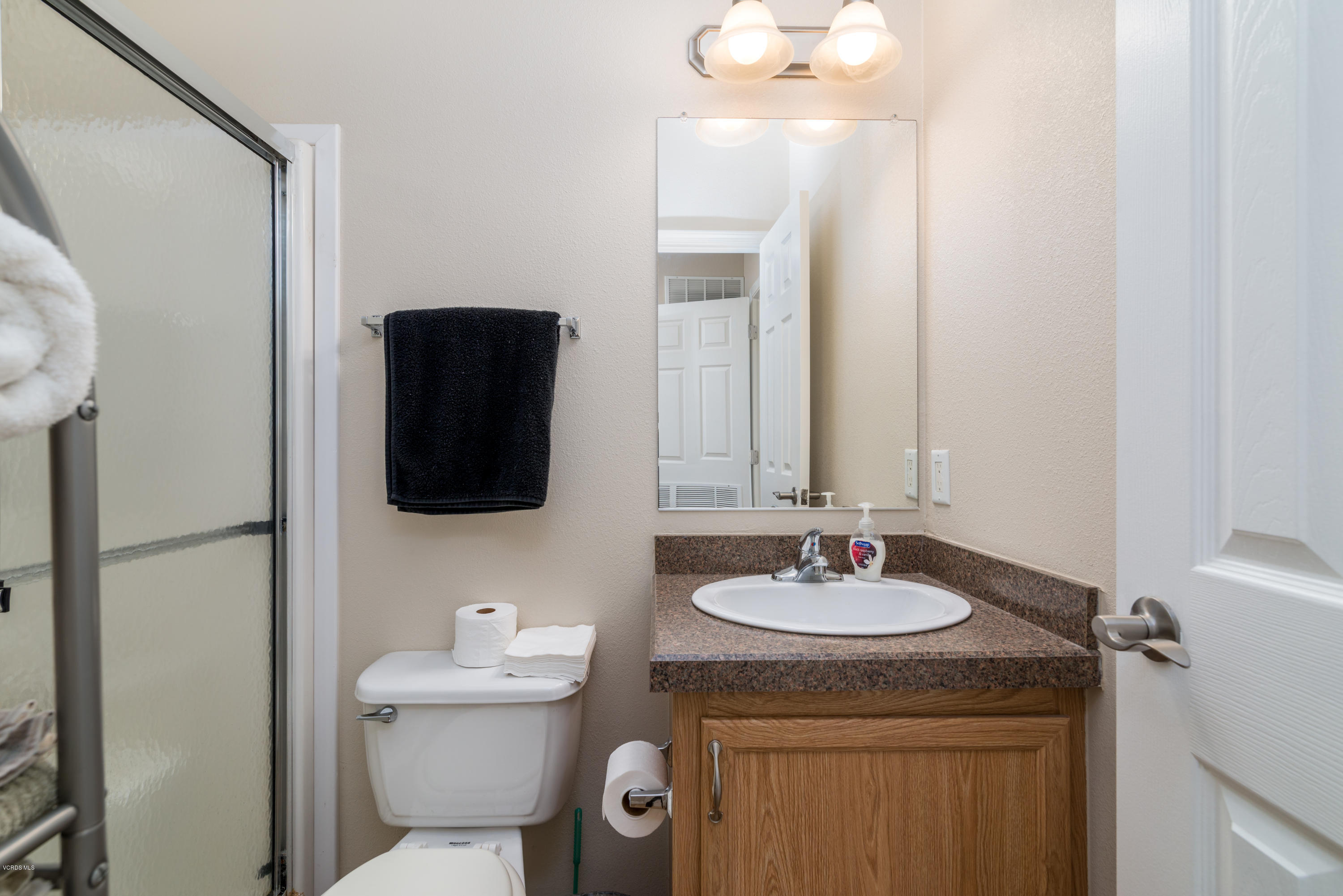 2132 Bluejay Avenue Oxnard, CA 93033 - Photo 15 of 20 a bathroom with a granite countertop sink a toilet and a mirror