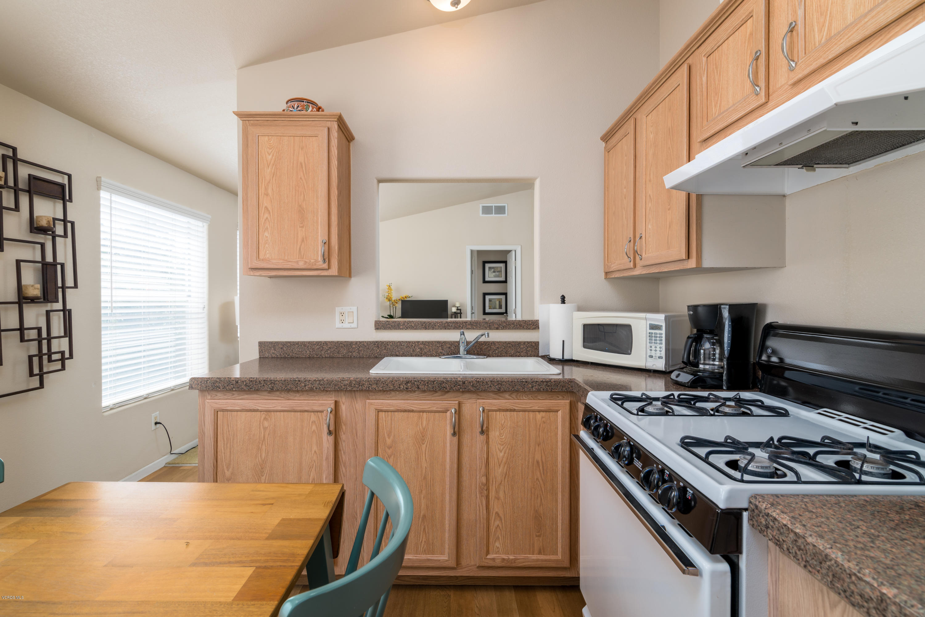 2132 Bluejay Avenue Oxnard, CA 93033 - Photo 6 of 20 a kitchen with a stove a sink and a window