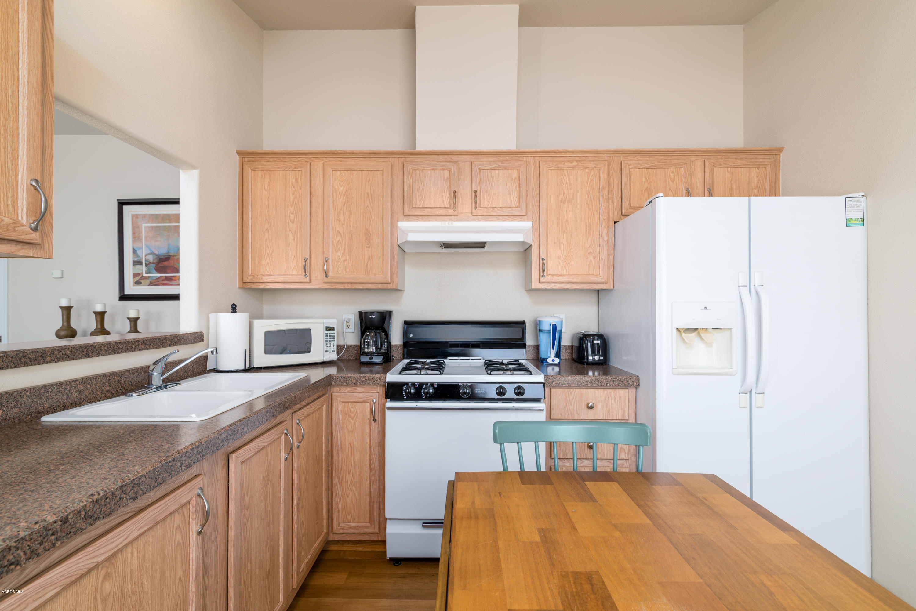 2132 Bluejay Avenue Oxnard, CA 93033 - Photo 8 of 20 a kitchen with stainless steel appliances a stove a sink and a refrigerator