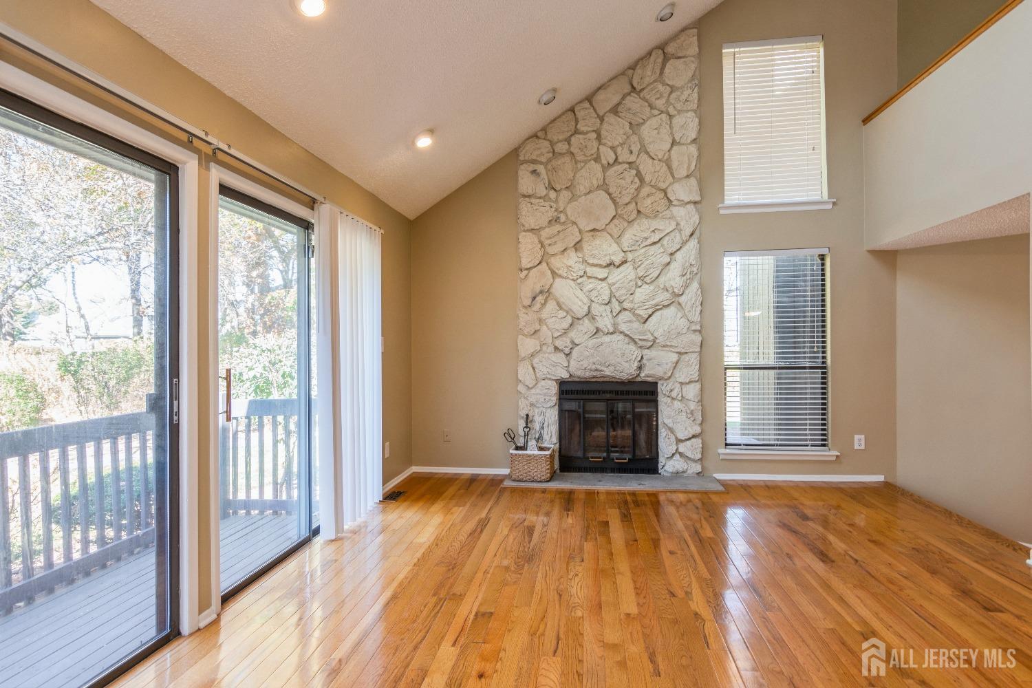 464 Westgate Drive Edison, NJ 08820 - Photo 5 of 31 a view of empty room with wooden floor and fireplace