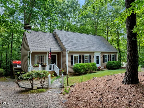 a view of a house with a yard and plants