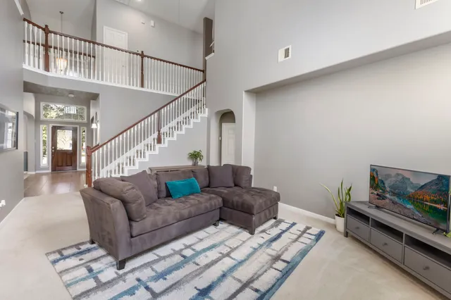 a living room with furniture and wooden floor