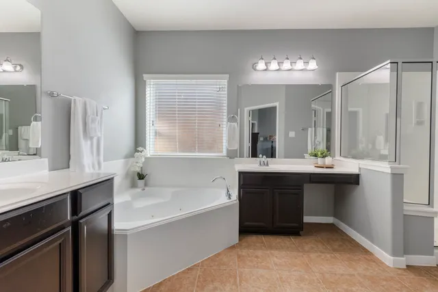 a bathroom with a sink double vanity granite and a mirror