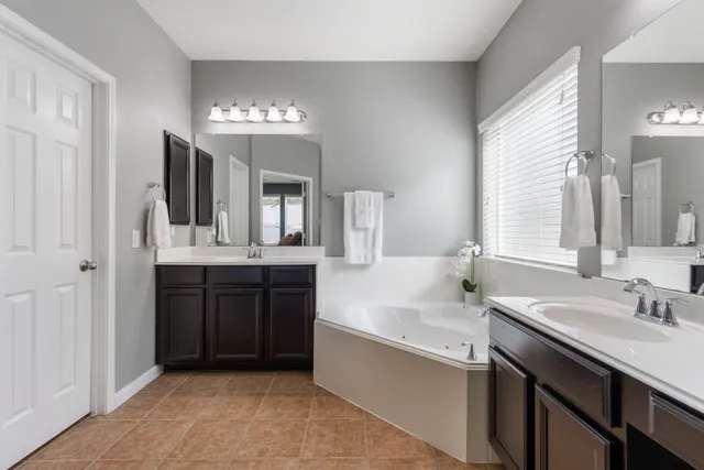 a bathroom with a sink double vanity and a mirror