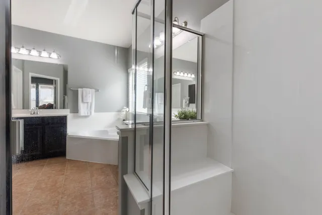 a bathroom with a double vanity sink and a mirror