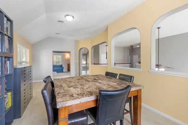 a view of a livingroom with furniture and a window