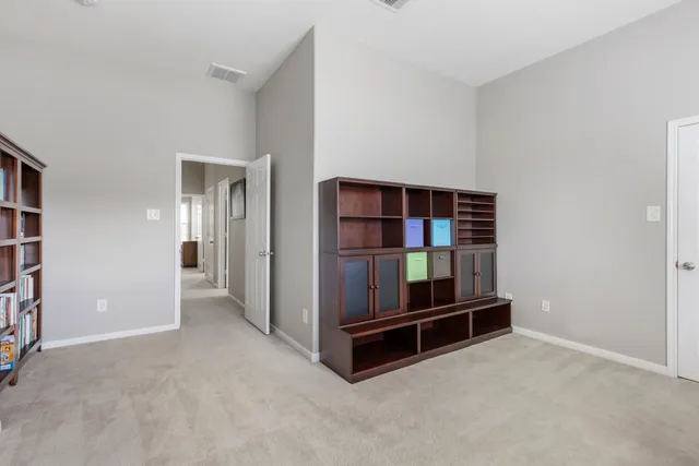 an empty room with a window and a fireplace