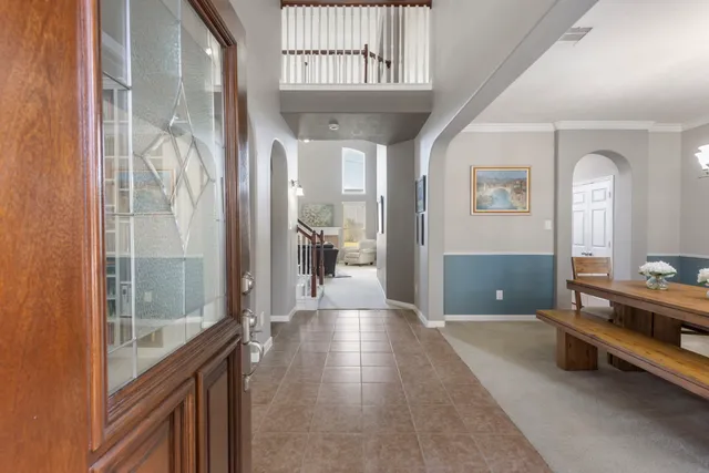 a view of a hallway with furniture and windows