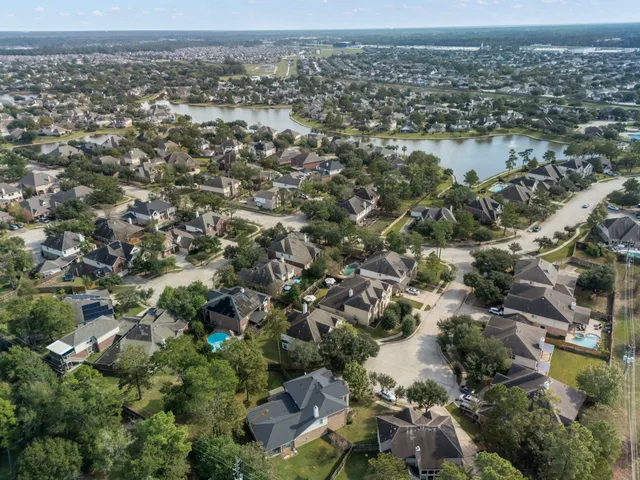 an aerial view of a house with a lake view
