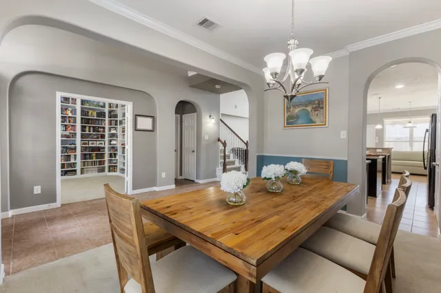 a view of a dining room with furniture and a chandelier
