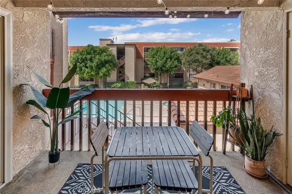 a view of balcony with wooden floor and outdoor seating