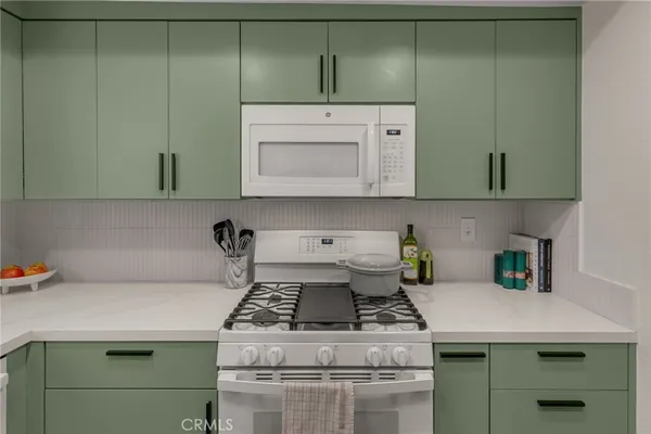 a kitchen with a stove and cabinets