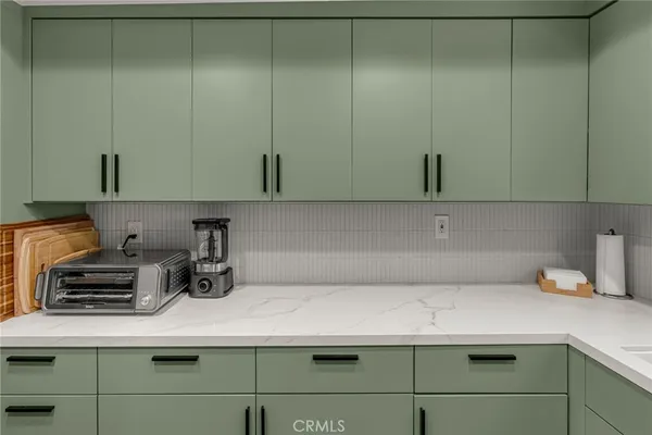 a kitchen with a refrigerator and cabinets