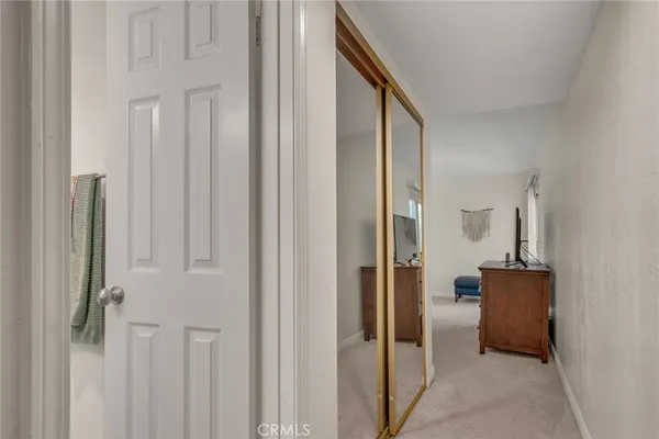a view of a hallway with closet and couch