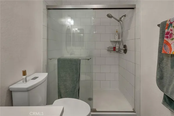 a bathroom with a shower a toilet and a sink