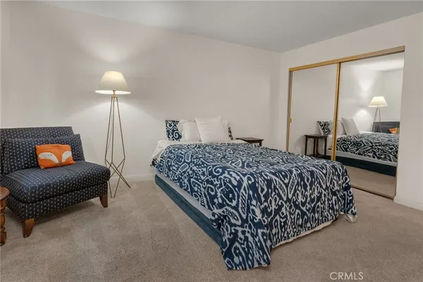 a bedroom with a bed and lamp