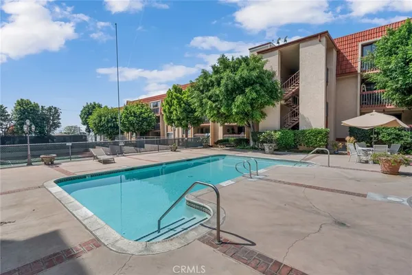 a swimming pool with outdoor seating and yard