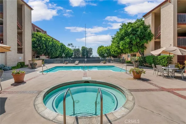 an outdoor space with swimming pool and furniture