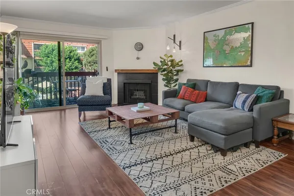 a living room with furniture a table and a fireplace