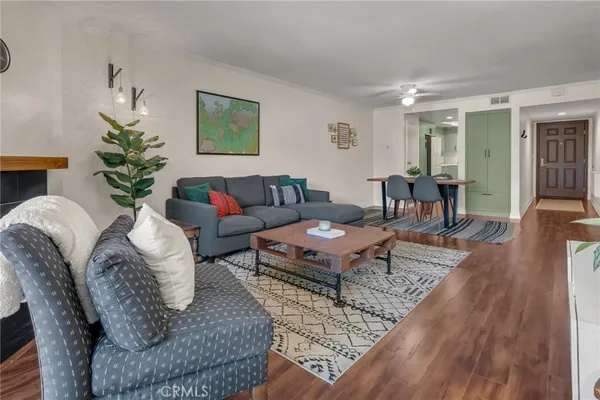a living room with furniture wooden floor and window