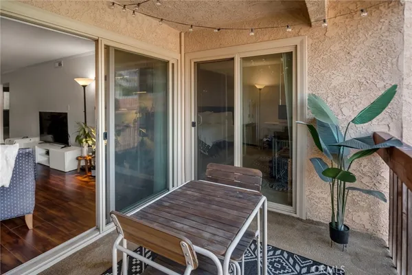 a balcony with table and chairs