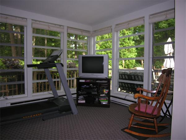 89 Brook Trail Road Concord, MA 01742 - Photo 10 of 18 a living room with patio furniture and a flat screen tv
