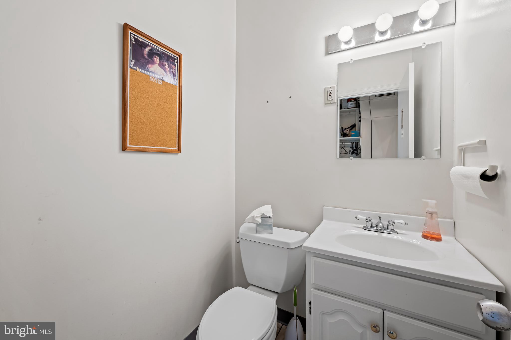 212 Duke Of Gloucester Street Annapolis, MD 21401 - Photo 6 of 23 a bathroom with a toilet sink and mirror