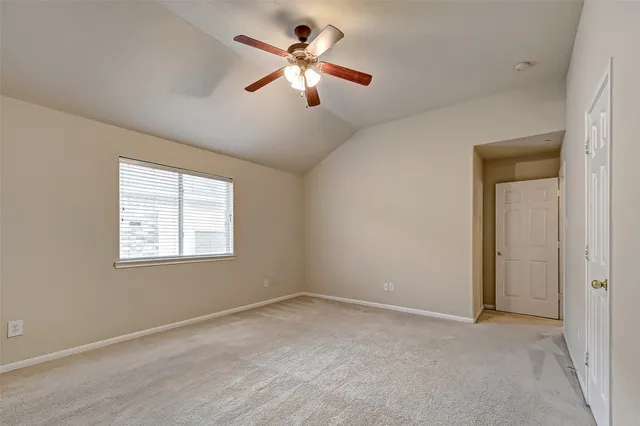a view of room with a ceiling fan and window
