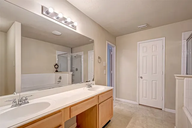 a bathroom with a sink double vanity and a mirror