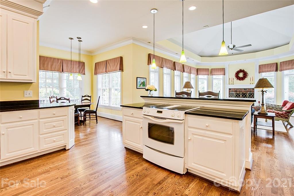 2215 Old Lexington Road Asheboro, NC 27205 - Photo 11 of 48 a kitchen with stainless steel appliances granite countertop wooden floors and white cabinets