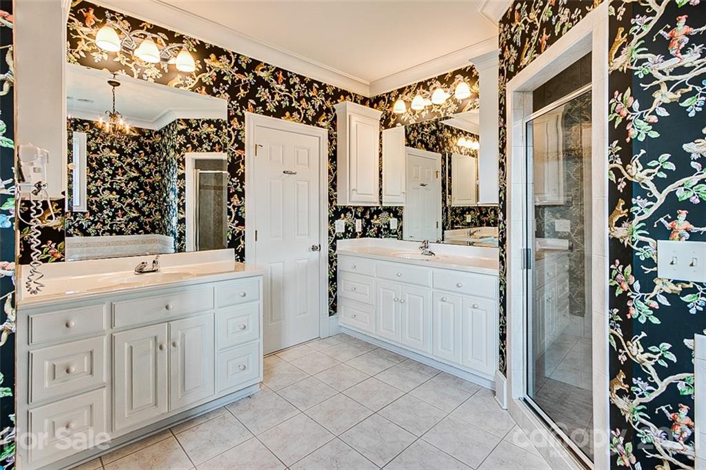 2215 Old Lexington Road Asheboro, NC 27205 - Photo 23 of 48 a bathroom with a double vanity sink a mirror a shower and vanity