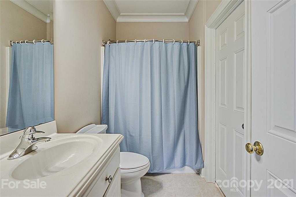 2215 Old Lexington Road Asheboro, NC 27205 - Photo 28 of 48 a bathroom with a sink a toilet and shower curtain