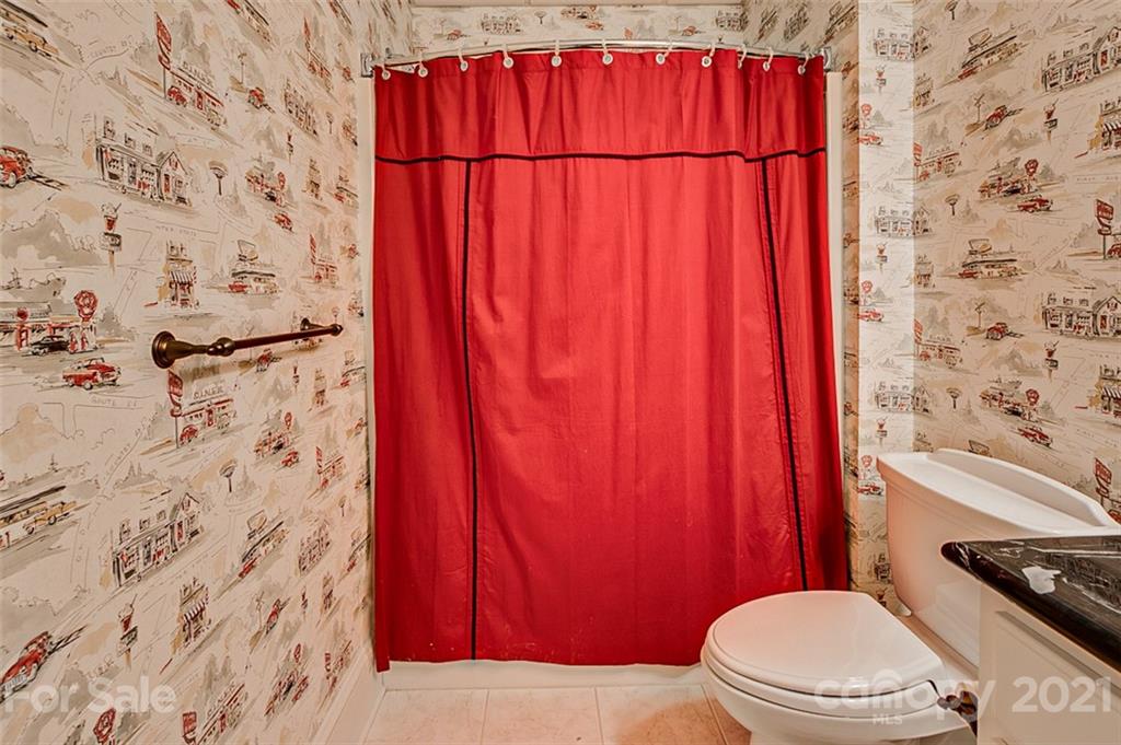 2215 Old Lexington Road Asheboro, NC 27205 - Photo 34 of 48 a bathroom with a toilet and a shower curtain
